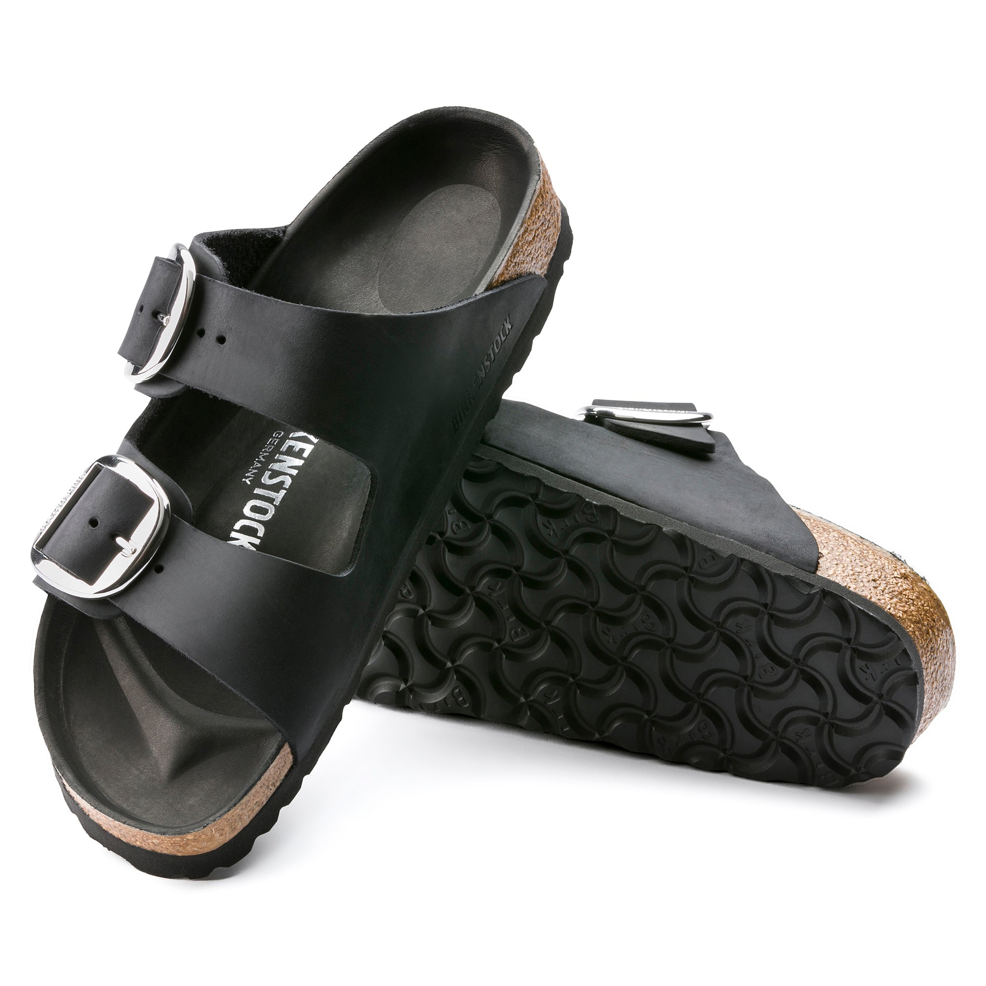 Black Birkenstock Arizona sandals with two wide leather straps, large silver buckles, and a cork-latex footbed.