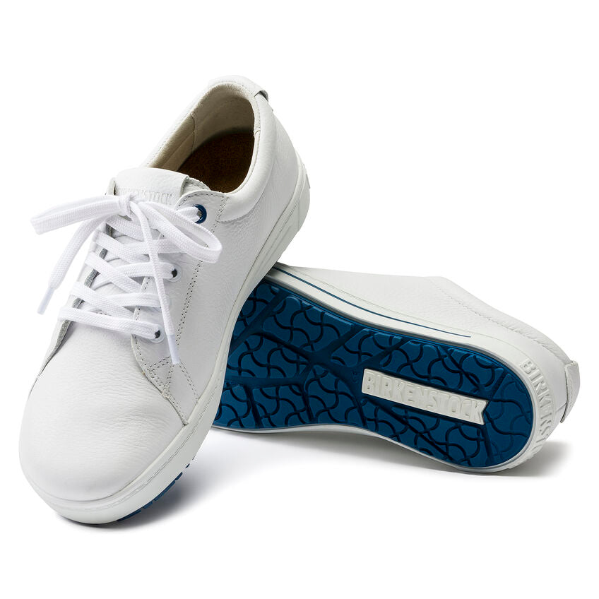 Pair of white leather Birkenstock sneakers featuring white laces and a distinctive blue patterned rubber sole.
