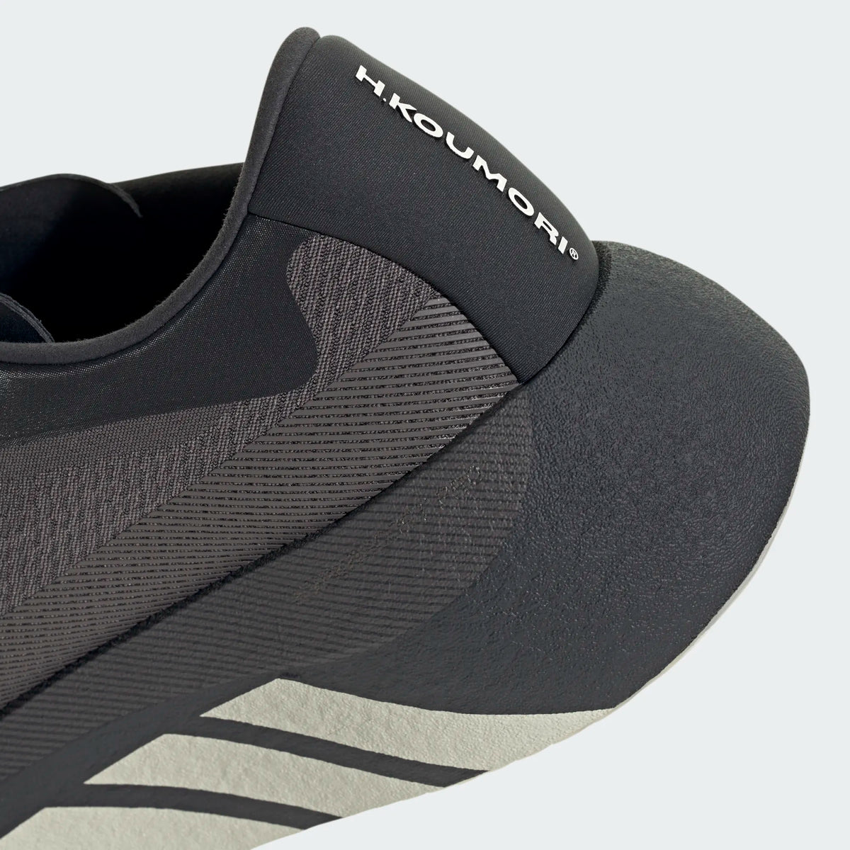 Close-up of black Adidas Hyperboost Edge Hermanos Koumori running shoe featuring a textured upper and branded heel collar.