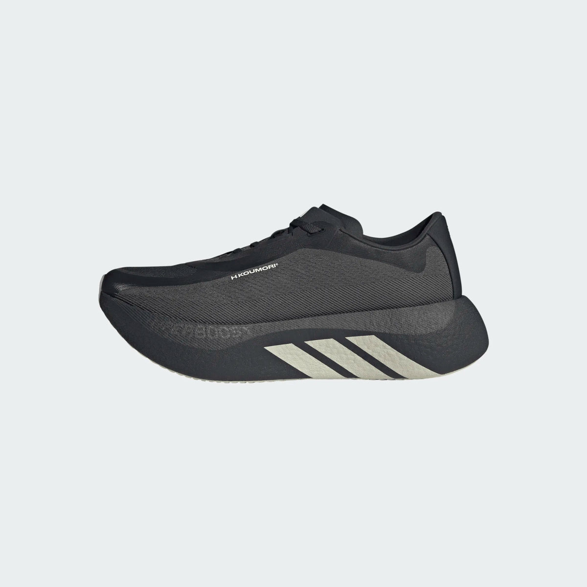 Black Adidas Hyperboost Edge Hermanos Koumori running shoe with a thick, sculpted midsole and white side stripes.