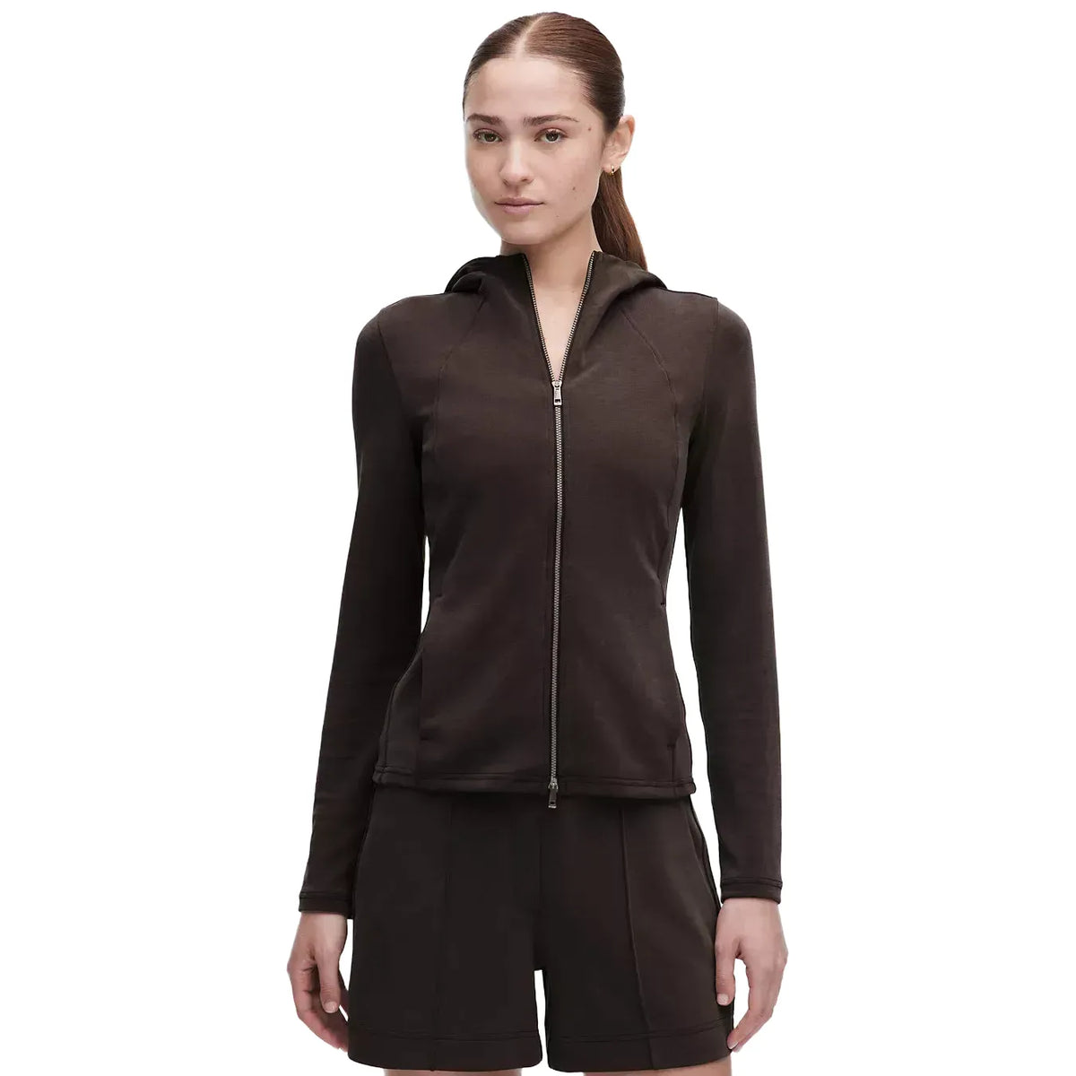Woman wearing a slim-fit, dark brown Lululemon Softstreme full-zip hoodie with a hood and two-way zipper.