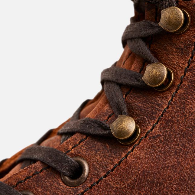 Close-up of Red Wing Blacksmith boot in Copper Rough & Tough leather with brass speed hooks and flat waxed laces.