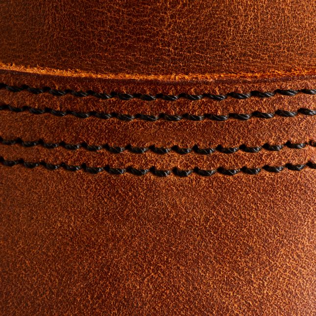 Close-up of Copper Rough & Tough leather on a Red Wing Iron Ranger boot featuring durable black triple-stitch construction.