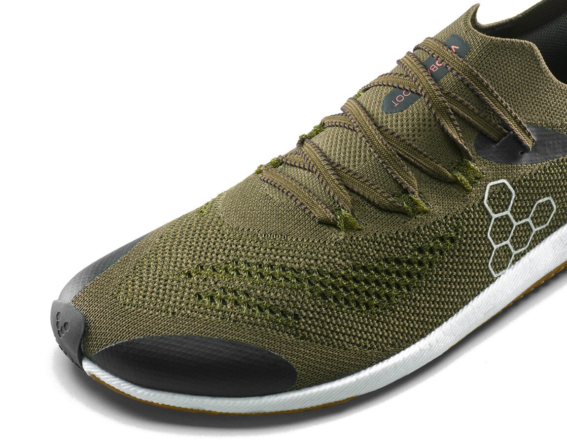 Olive green Vivobarefoot Primus Flow Knit running shoe with a breathable knit upper, wide toe box, and flexible sole.