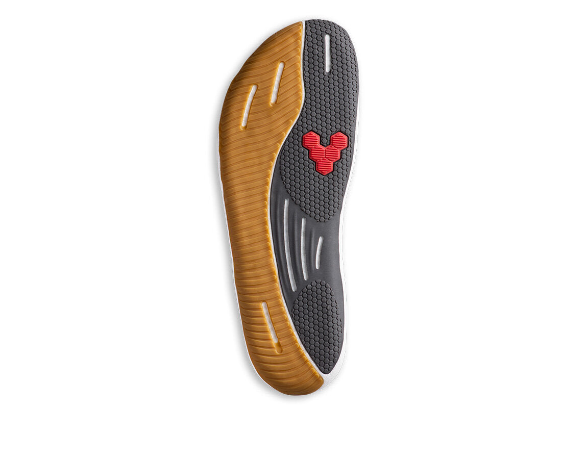 Vivobarefoot Primus Flow Knit barefoot shoe sole with gum rubber, grey textured grip, and red logo detail.