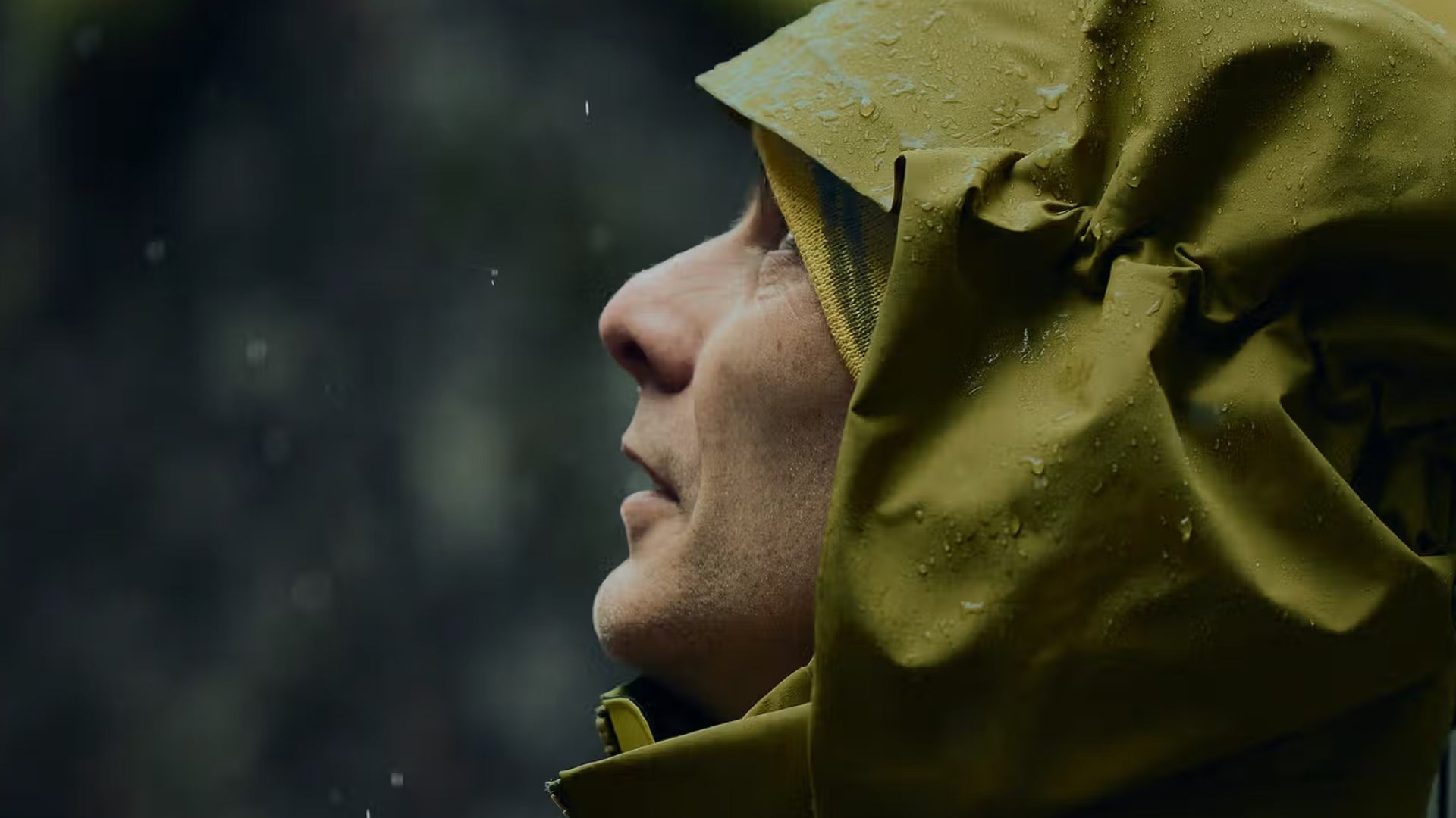 Person wearing a arcteryx raincoat in a rainy setting